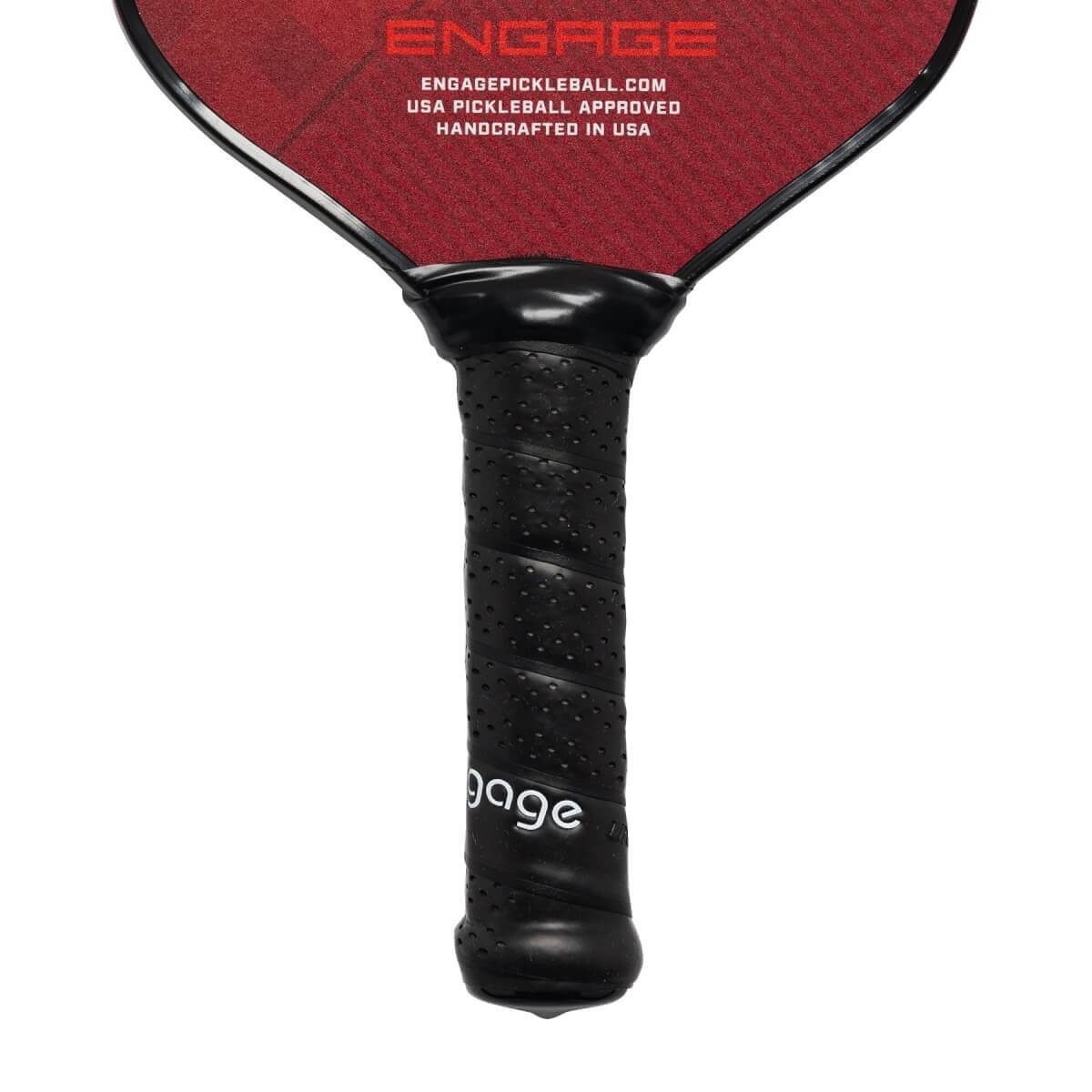 Close-up of a black pickleball paddle grip with perforations and white engage text.