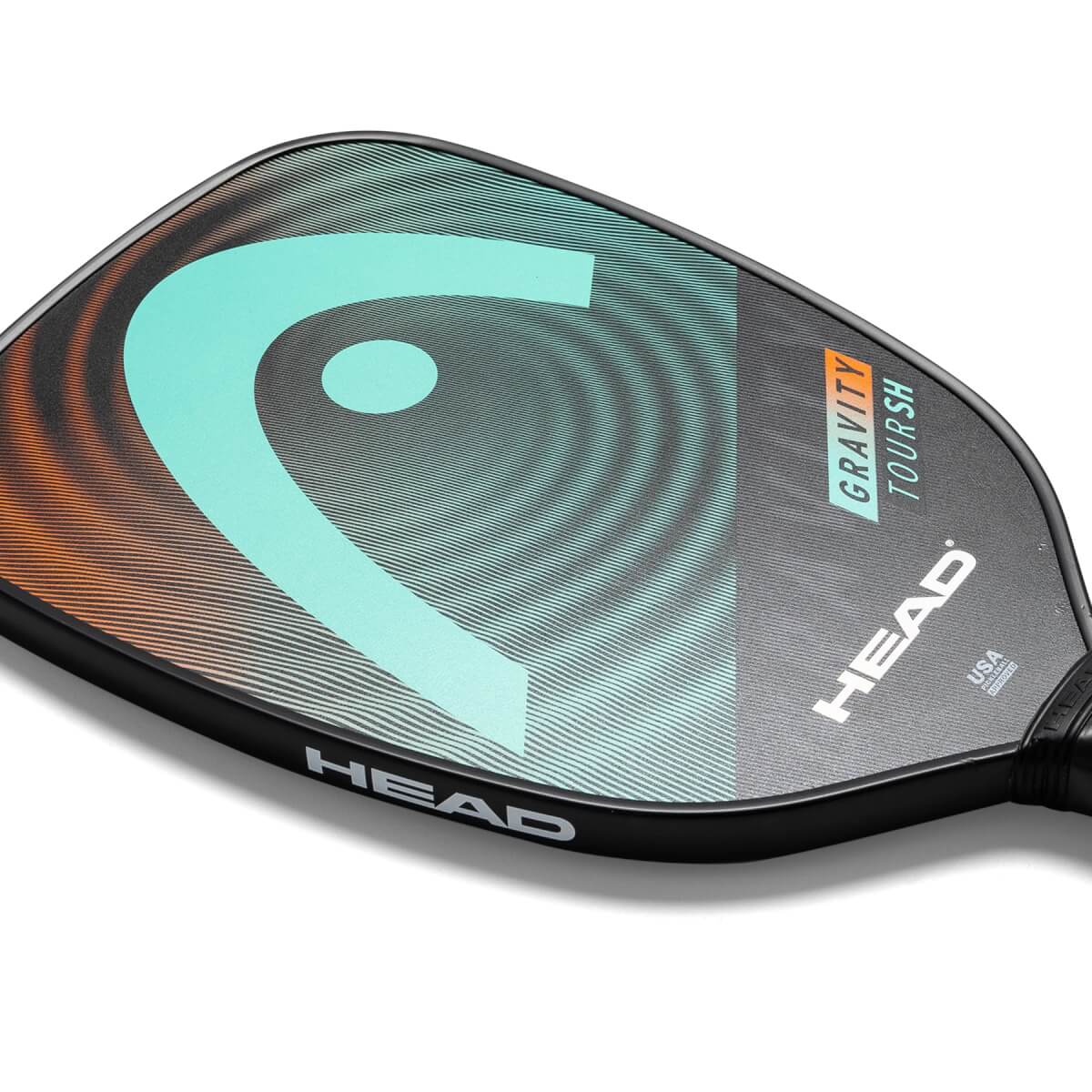 Corner view of a black pickleball paddle with a large teal HEAD logo and GRAVITY TOUR SH text.