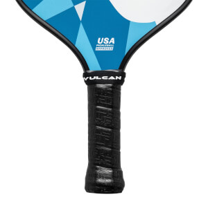 Close-up of a black pickleball paddle grip with Vulcan branding and a blue geometric pattern on the paddle head.