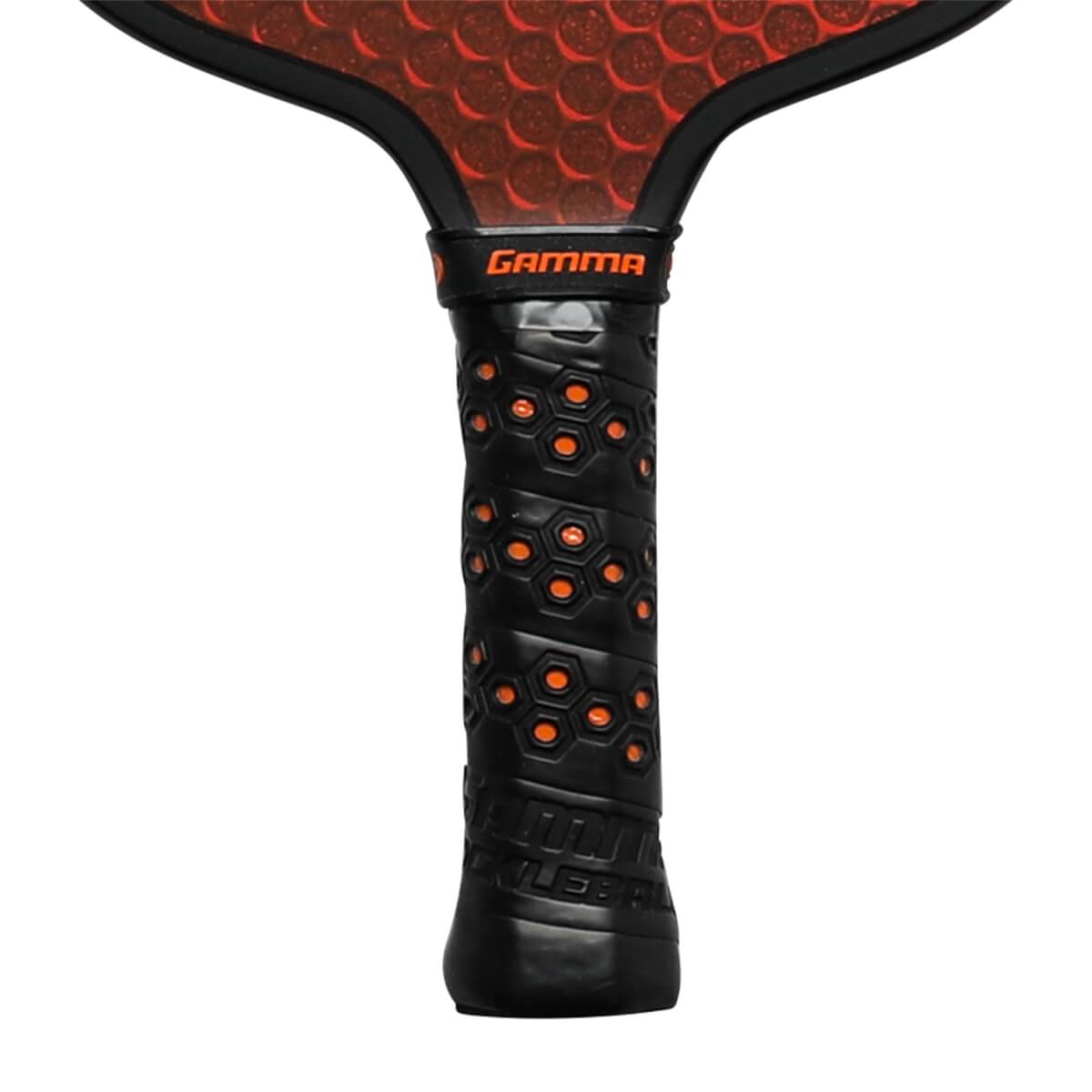 Close-up of a black pickleball paddle grip with orange hexagonal accents and GAMMA branding.