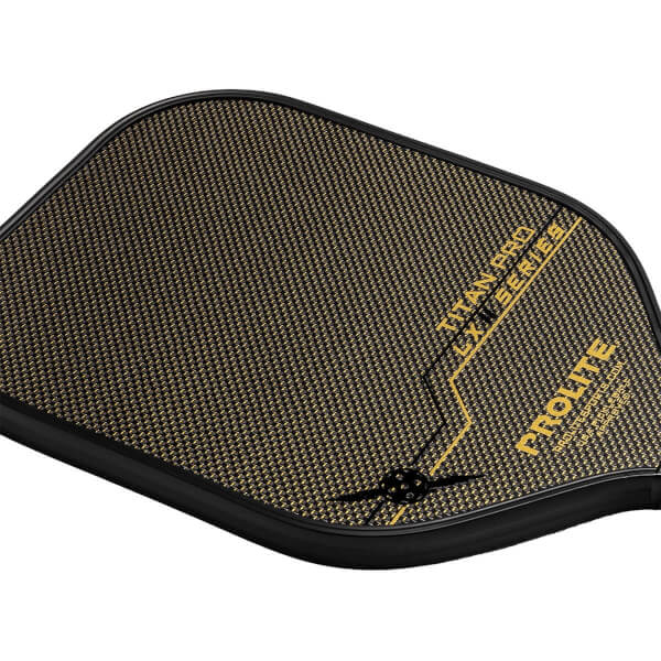 Top-down view of a black and gold pickleball paddle with carbon fiber texture, TITAN PRO LXM SERIES and PROLITE text.