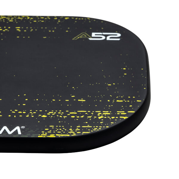 Corner view of a black pickleball paddle with yellow speckle pattern and A52 logo.