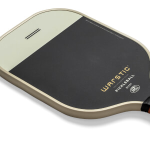 Top-down view of a black and cream pickleball paddle with Warstic branding and USA Pickleball logo.