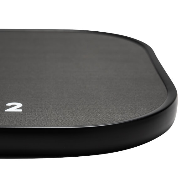 Corner view of a black pickleball paddle with a textured surface and a white number 2.
