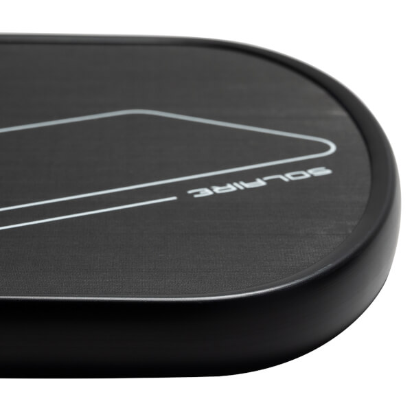 Corner view of a black pickleball paddle with white SOLAIRE text and a geometric design.