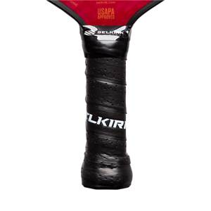 Close-up of a black pickleball paddle grip with white SELKIRK text and USAPA approved label.