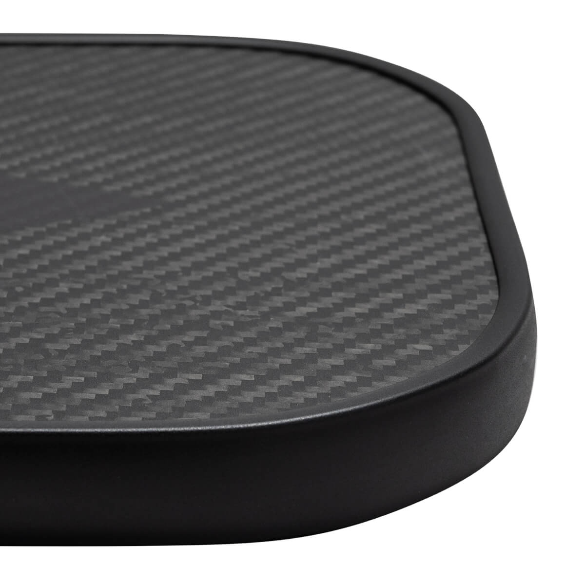 Close-up of a black pickleball paddle with a carbon fiber surface and black edge.