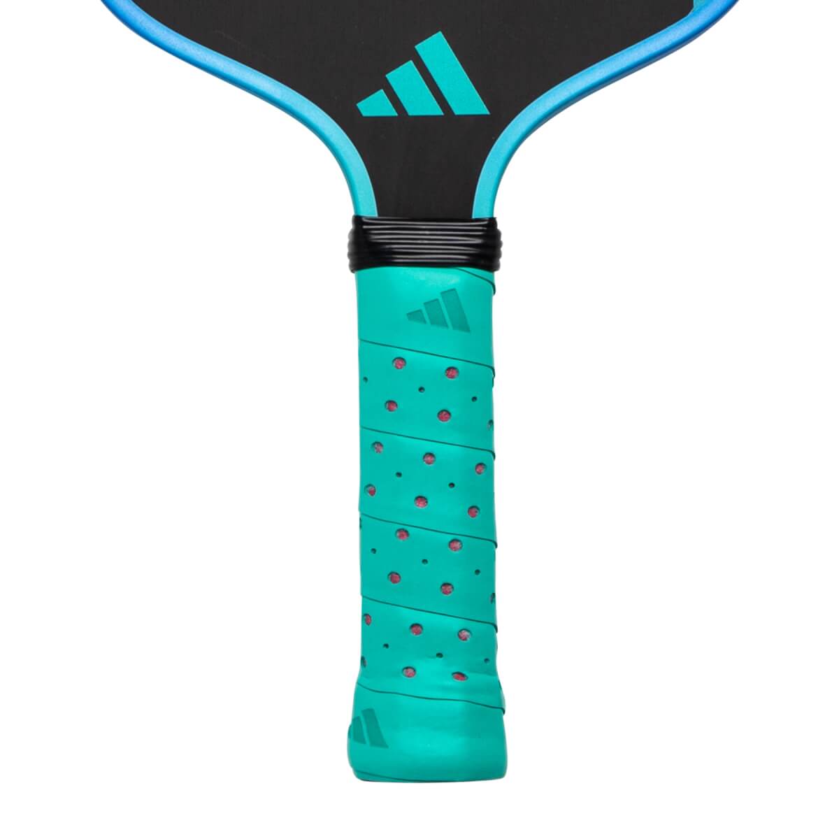Close-up of a teal pickleball paddle with a perforated grip showing red dots and a black throat with a teal Adidas logo.