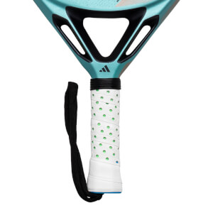 Close-up of the grip and lower head of a teal Adidas padel racket, showing the white grip with green dots and the Adidas logo.