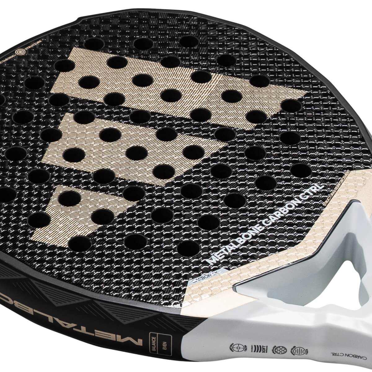 Close-up of a black and gold adidas Metalbone Carbon Ctrl 3.4 padel racket with a textured surface and visible holes.