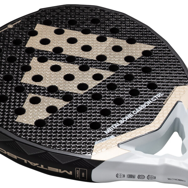 Close-up of a black and gold adidas Metalbone Carbon Ctrl 3.4 padel racket with a textured surface and visible holes.