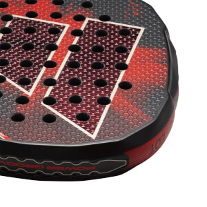 Corner view of a black and red padel racket with hexagonal pattern, showing "POWER GROOV" text.