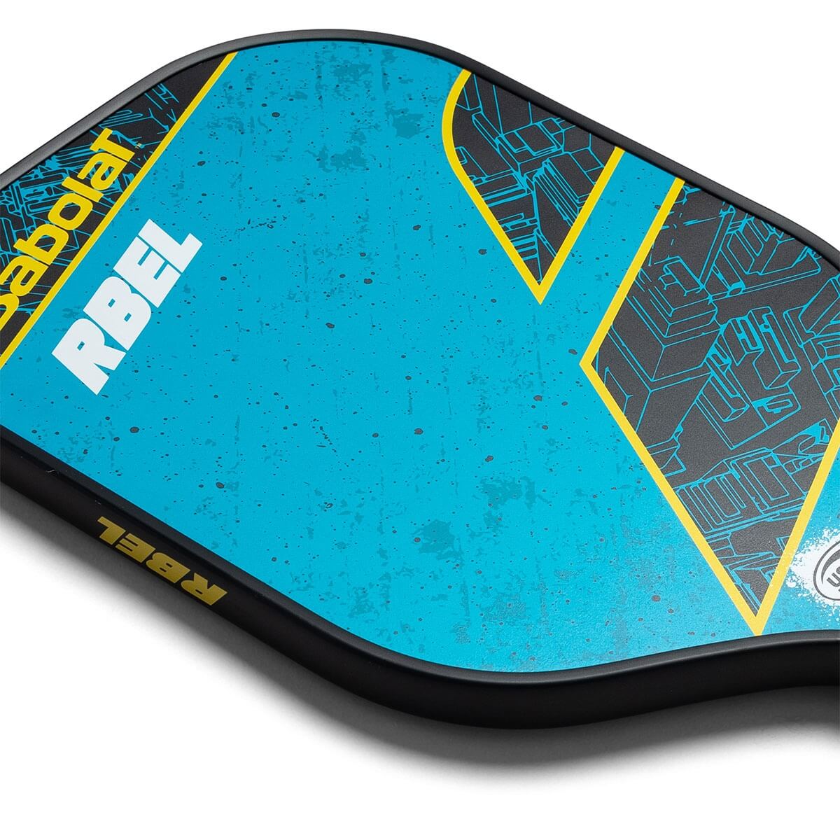Corner view of a blue Babolat RBEL Hybrid pickleball paddle with yellow accents and a geometric design.