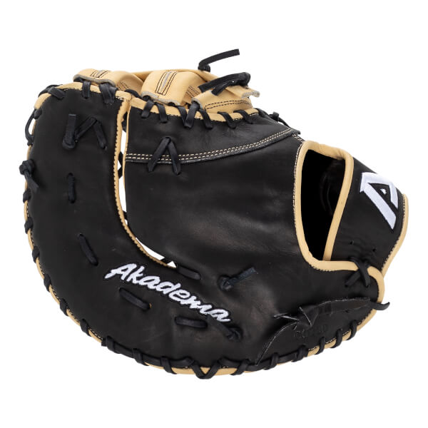 Angled front view of a black and tan glove with white Akadema script, a white A logo, and black lacing.