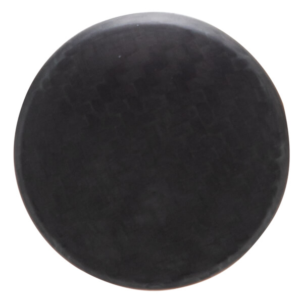 Top-down view of a black, circular puck with a matte finish.