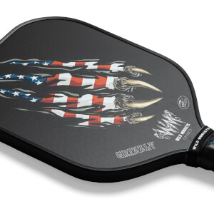 Corner view of a black pickleball paddle with a claw and American flag graphic, and GRIZZLY text.