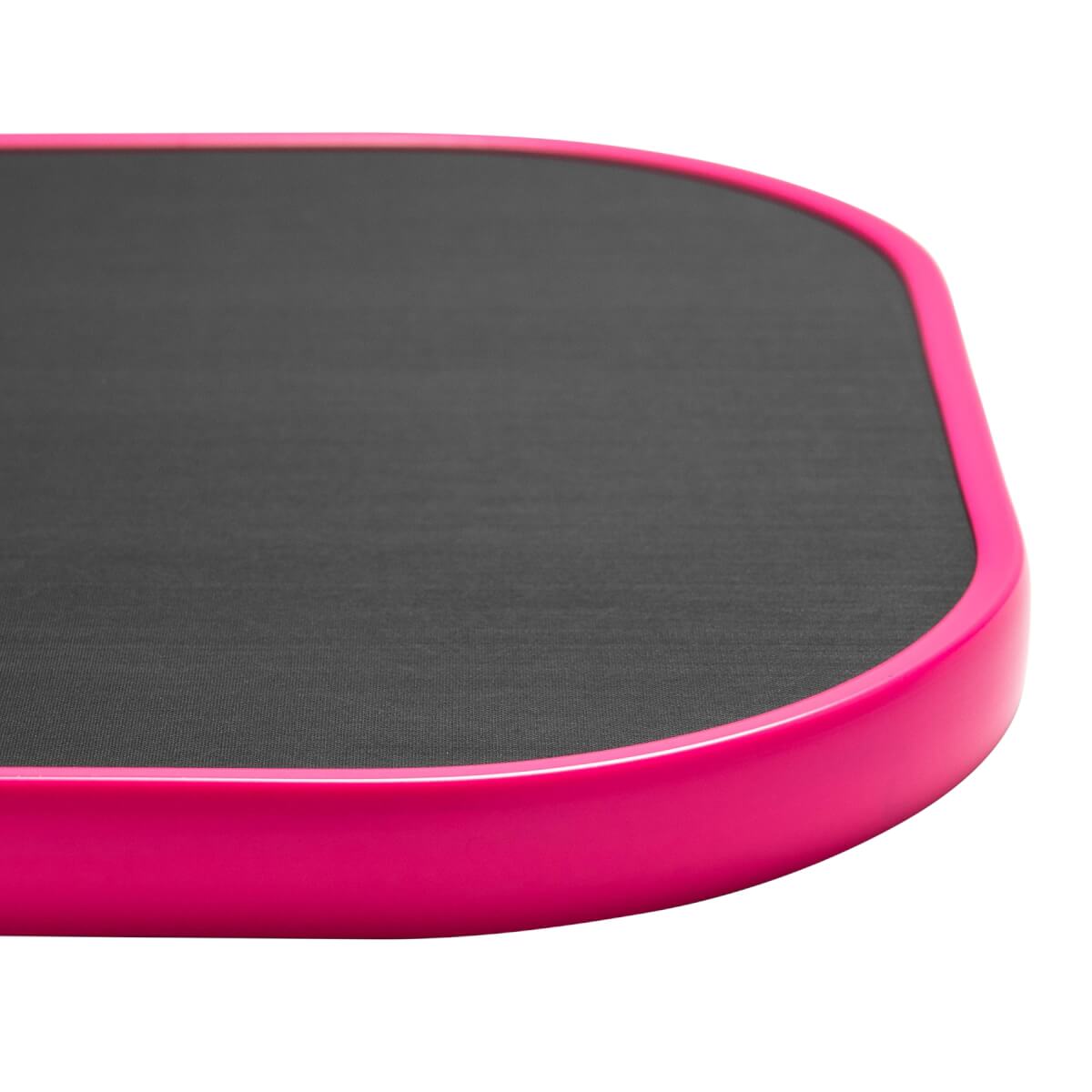 Corner view of a pink pickleball paddle with a textured black surface.