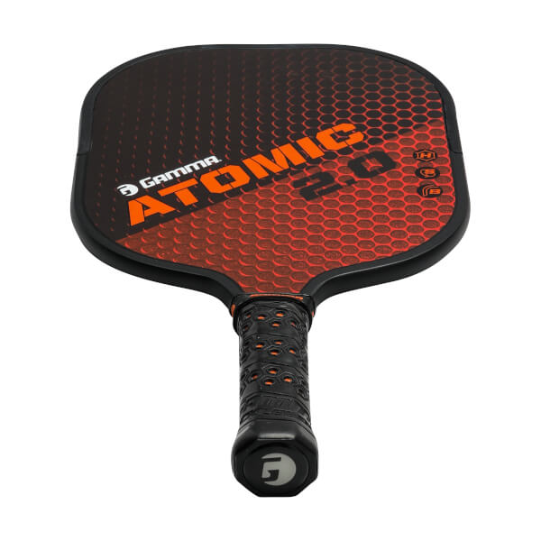 Top-down view of a black and orange GAMMA Atomic 2.0 pickleball paddle with honeycomb pattern and textured grip.