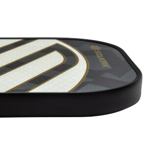 Corner view of a black pickleball paddle with white and gold stripes and Selkirk branding.