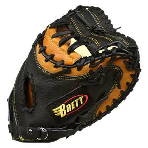 Top-down view of a black and tan catchers mitt with yellow stitching and a Brett logo.