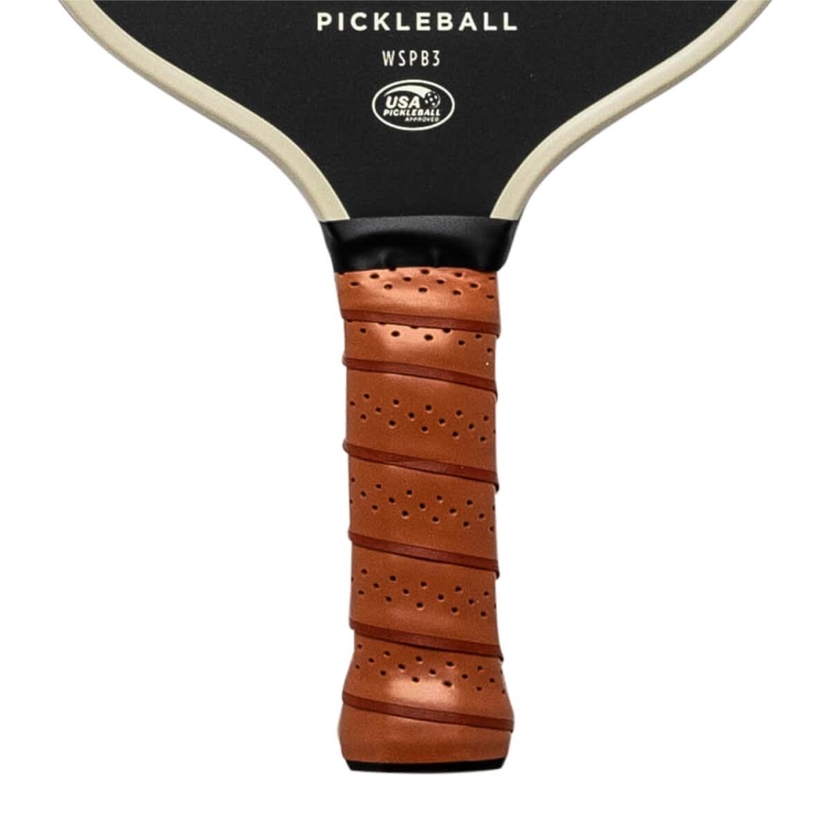 Close-up of a brown pickleball paddle grip with perforations and spiral stitching, showing PICKLEBALL WSPB3 and USA PICKLEBALL APPROVED text.