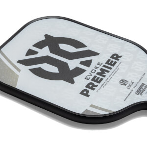 Corner view of a white pickleball paddle with a black logo, EVOKE PREMIER text, and USAPA APPROVED stamp.