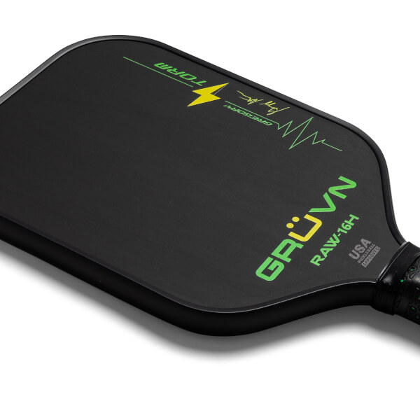 Corner view of a black GRUVN RAW-16H pickleball paddle with green text and a lightning bolt graphic.