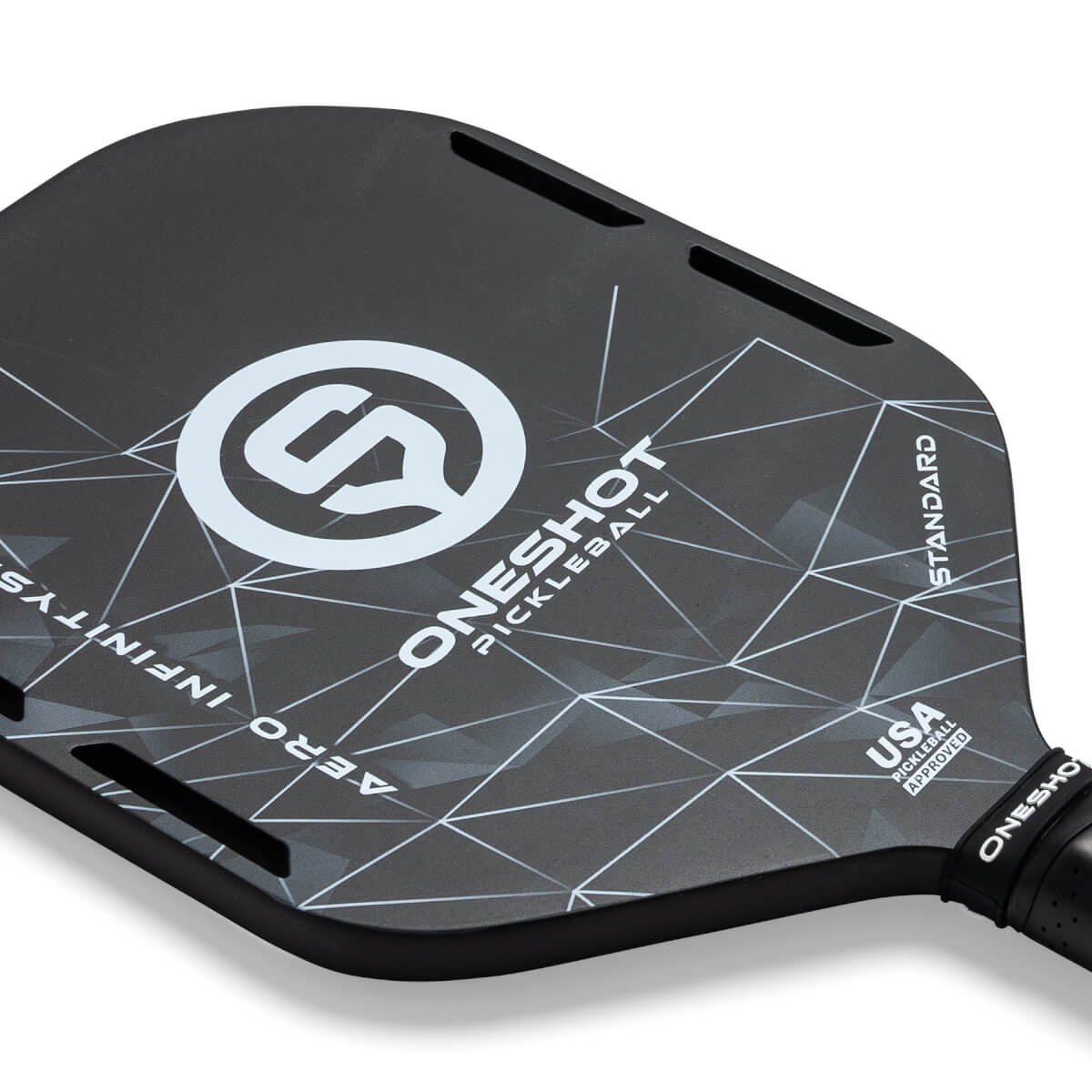 Top-down view of a black pickleball paddle with a white geometric pattern, ONESHOT PICKLEBALL text, and USA PICKLEBALL APPROVED stamp.