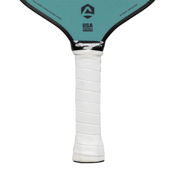 Top-down view of a teal pickleball paddle with a white grip, USA Pickleball Approved logo, and Polymer Honeycomb Core text.