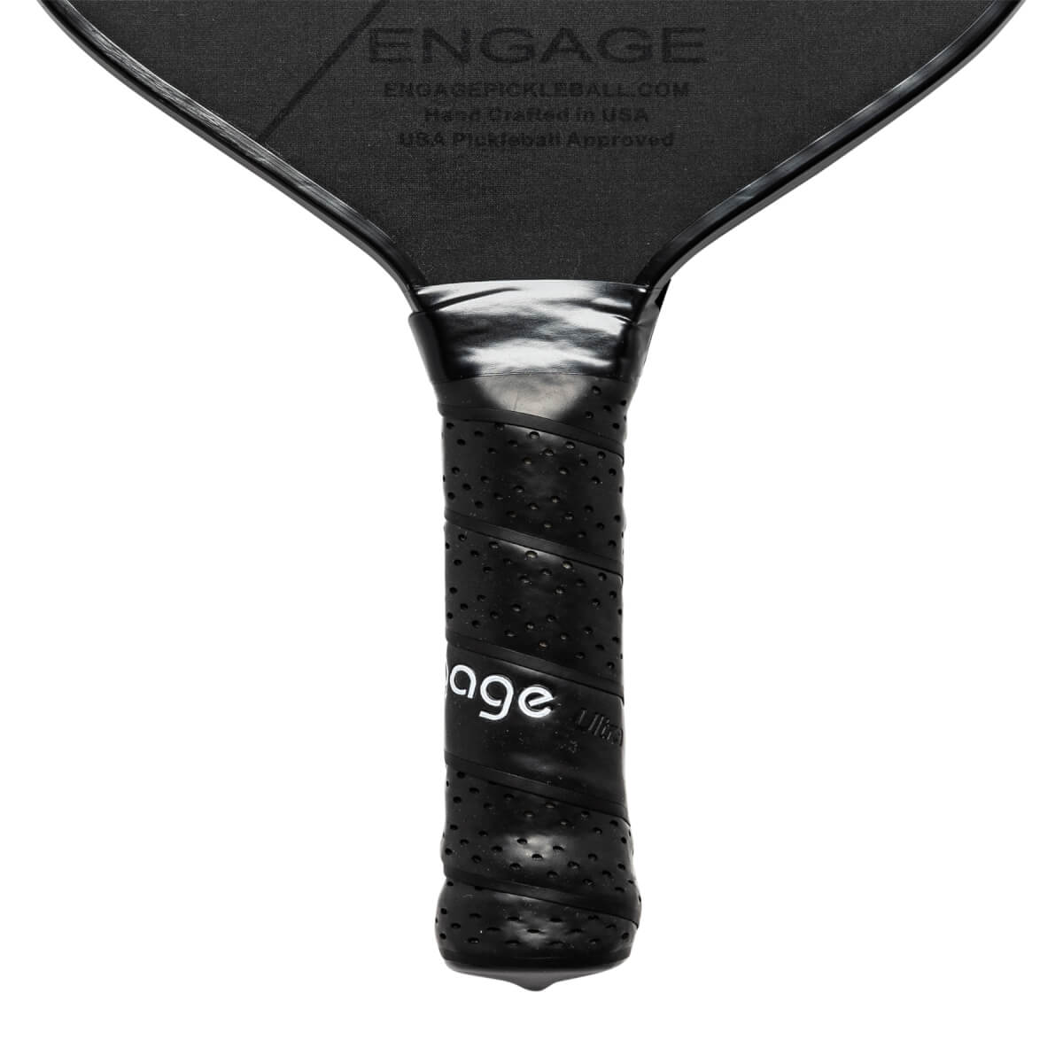 Close-up of a black pickleball paddle grip with perforated texture and Engage branding.