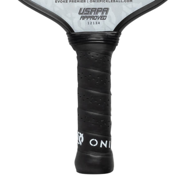 Close-up of a black pickleball paddle grip with perforated texture and white ONIX logo.