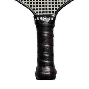 Close-up of a black pickleball paddle grip with ARMOUR text and a perforated surface.