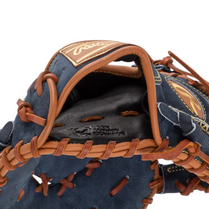 Close-up of a blue denim baseball glove with tan leather lacing and a Rawlings logo.