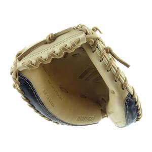 Interior view of a tan and navy catchers mitt with Marucci logo and 33 1/2 inch text.