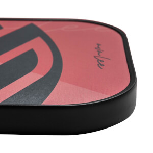Corner view of a red pickleball paddle with black graphic design and AvaLee signature.