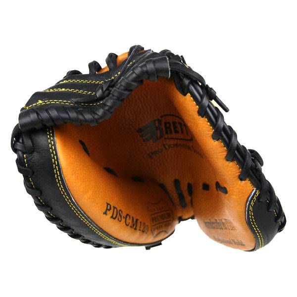 Interior view of a black and tan catchers mitt with PDS-CM120 and BRETT branding.