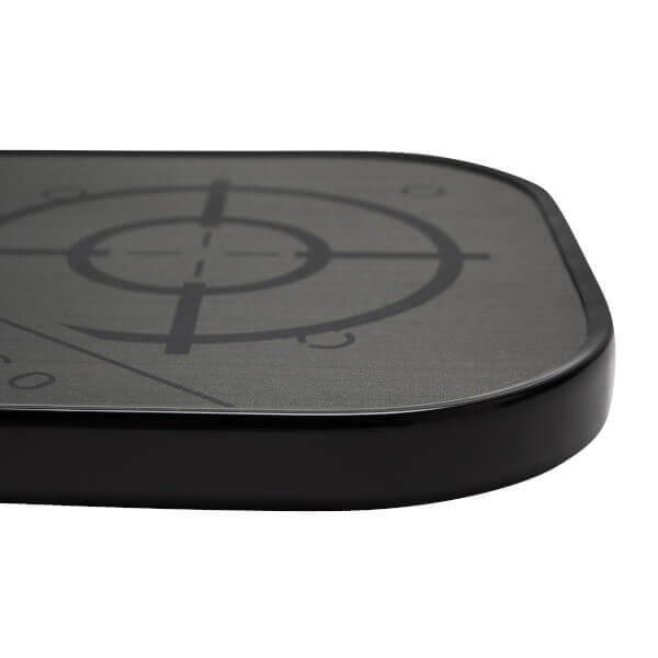Corner view of a black pickleball paddle with a textured surface and target graphic.