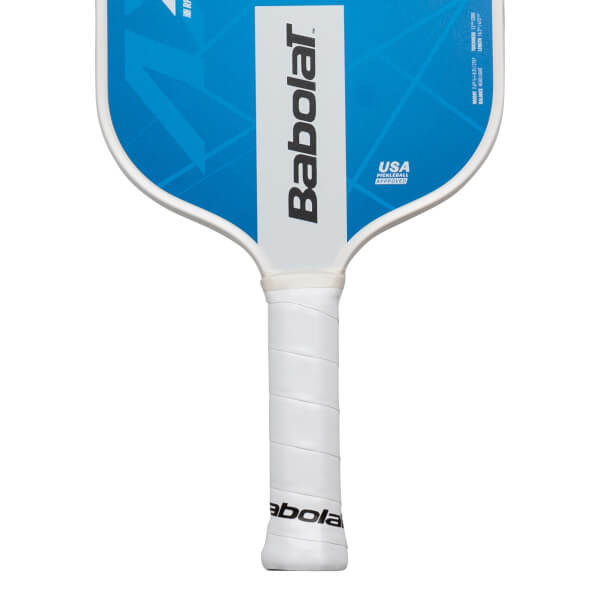 Close-up of the handle and upper face of a Babolat pickleball paddle, showing the white grip and blue face with white trim.