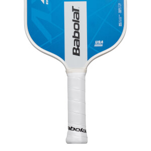 Close-up of the handle and upper face of a Babolat pickleball paddle, showing the white grip and blue face with white trim.