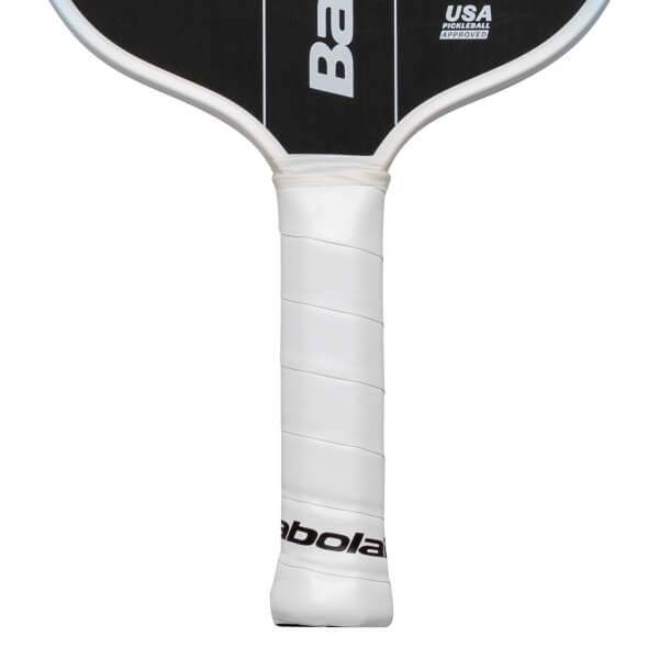 Close-up of a white pickleball paddle grip with "Babolat" logo and "USA PICKLEBALL APPROVED" text.