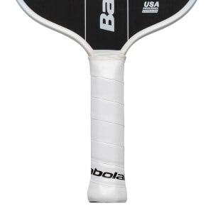Close-up of a white pickleball paddle grip with "Babolat" logo and "USA PICKLEBALL APPROVED" text.
