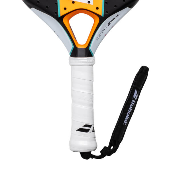 Close-up of a white Babolat Dyna Padel Racket handle with a black wrist strap and orange/blue throat accents.