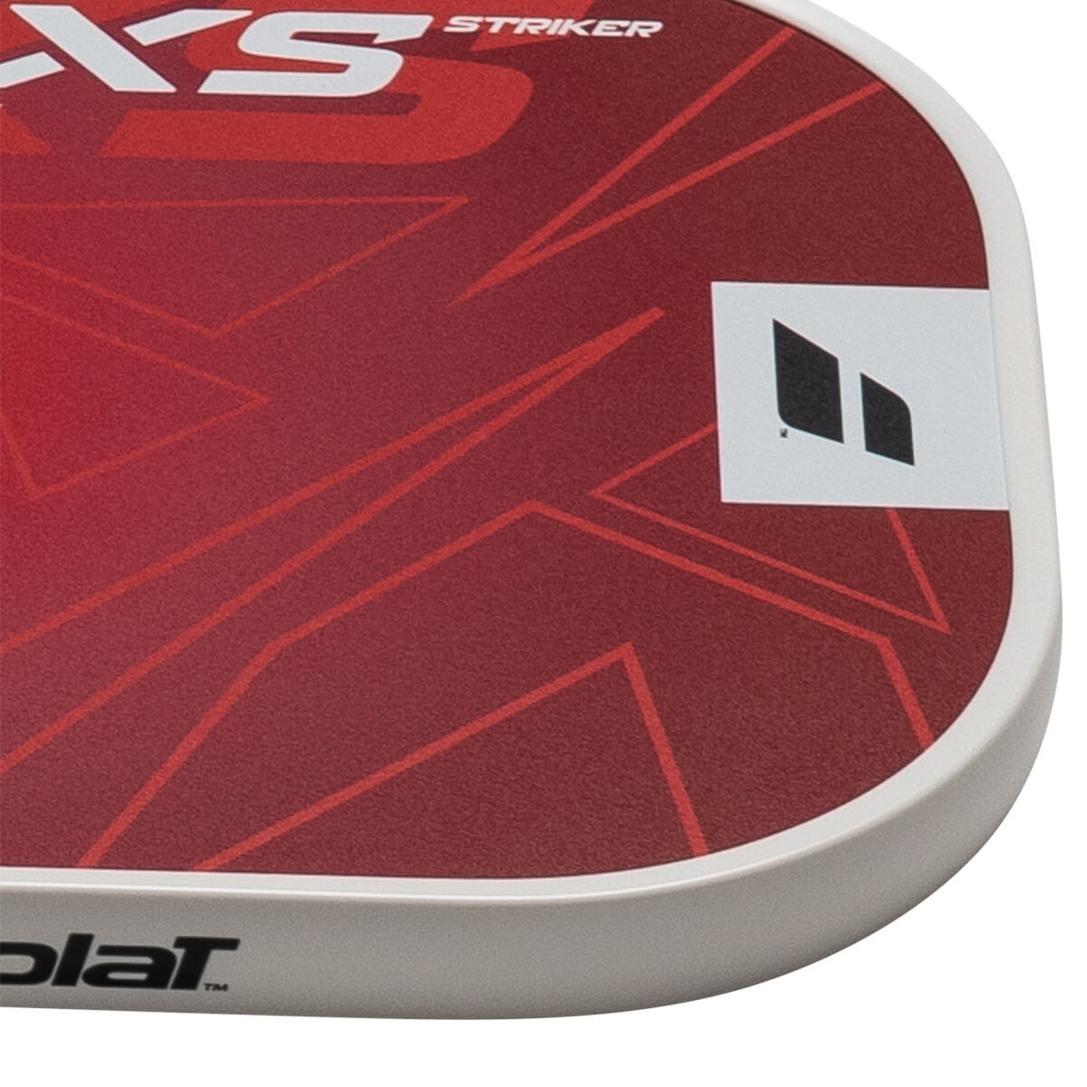 Corner view of a red paddle with white "XS STRIKER" text and a black logo.
