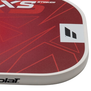 Corner view of a red paddle with white "XS STRIKER" text and a black logo.