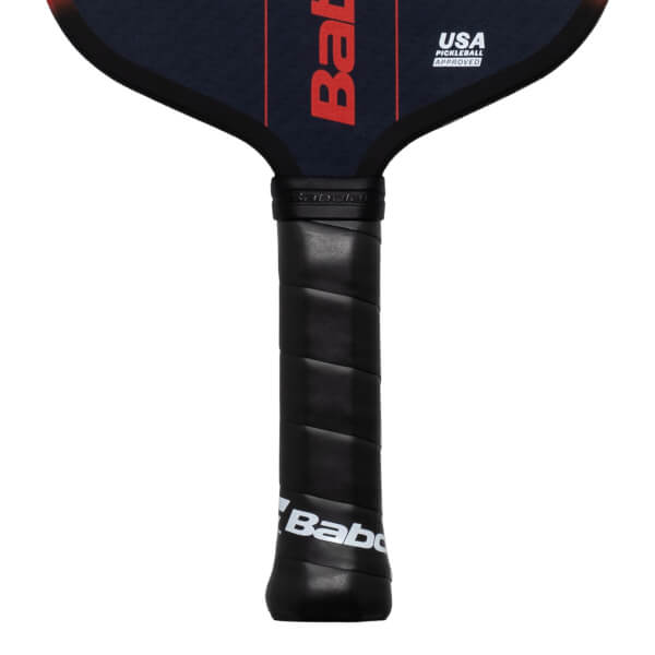 Close-up of a pickleball paddle handle showing the black grip with "Babolat" and "USA PICKLEBALL APPROVED" text.