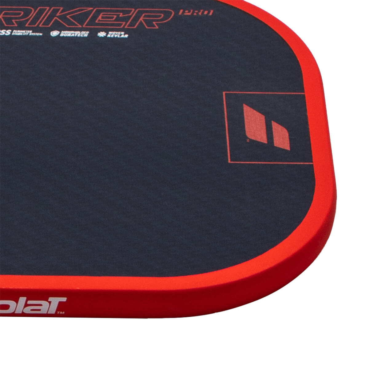 Corner view of a dark blue pad with red trim, showing "STRIKER PRO" and a red logo.