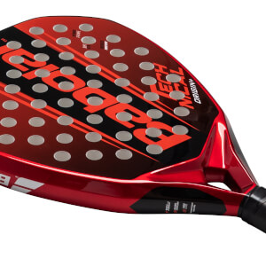 Top-down view of a red and black padel racket, showing the Babolat logo, "ORIGIN+", and circular holes.