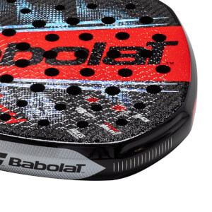 Corner view of a black and red Babolat padel racket with visible "Babolat" text and black holes.
