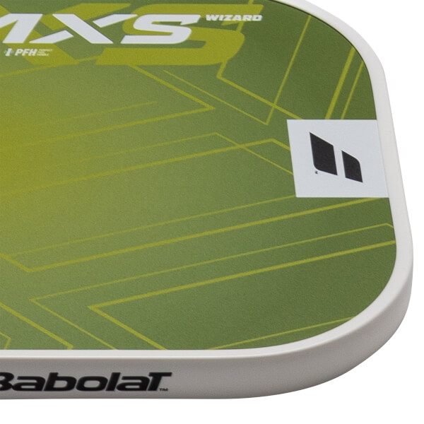 Corner view of a green and yellow patterned Babolat tennis racket grip with "MXS" and "WIZARD" text.