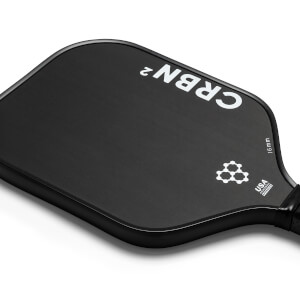Top-down view of a black pickleball paddle with white CRBN² branding and a USA Pickleball Approved logo.